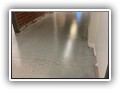 Two coats of low VOC clear epoxy. Notice most of the "ghosting" is gone in this section. Great character in the floor, large to medium aggregate, and cracks that were filled.