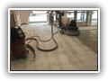 Here we have removed the carpet tiles and are grinding off the carpet adhesive. Notice the "ghosting" even after the aggressive grinding, using our heavy-duty grinder.  